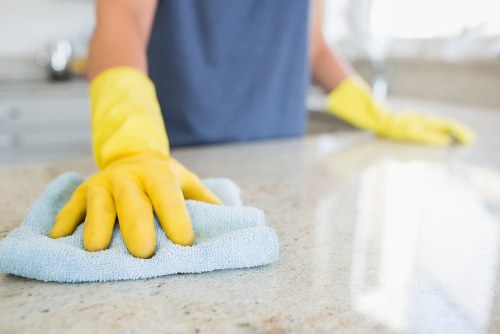 Deep cleaning kitchen surfaces during a move-out clean in South London